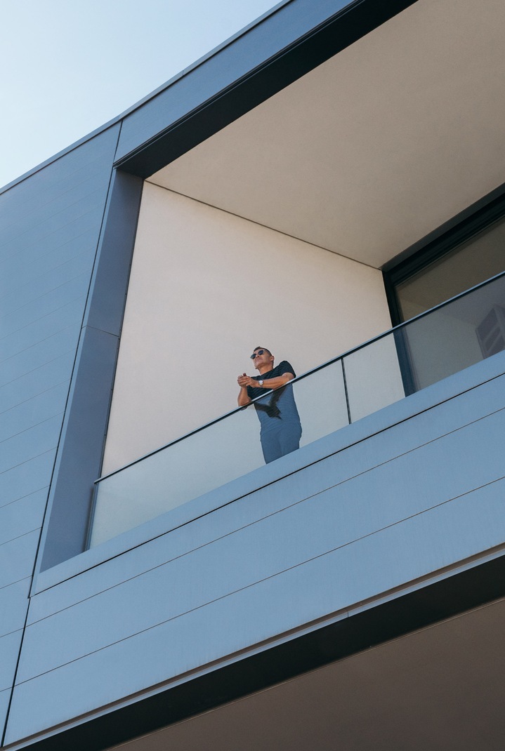 Tom Kristensen stoji na balkonu in opazuje okolico.